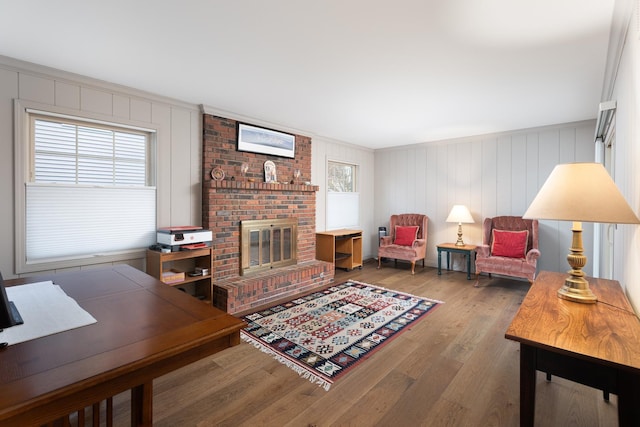 living area with plenty of natural light, a fireplace, and wood finished floors