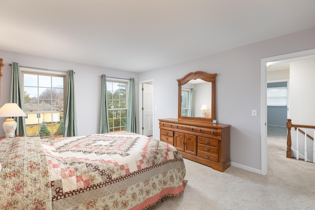 bedroom featuring baseboards and light colored carpet