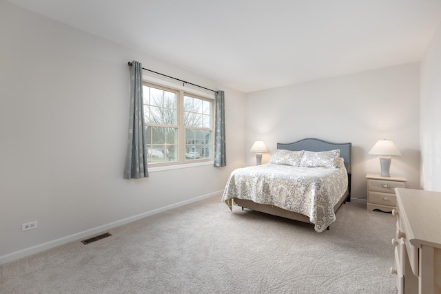 bedroom with carpet flooring, visible vents, and baseboards