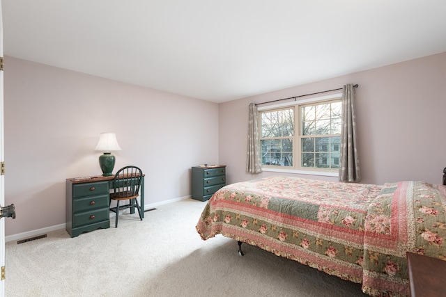 carpeted bedroom featuring baseboards and visible vents