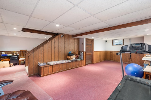 workout room featuring a drop ceiling, wainscoting, carpet, wood walls, and recessed lighting