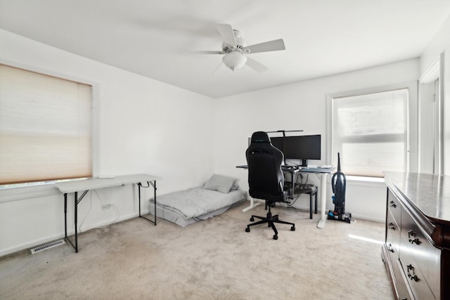 office featuring light carpet, visible vents, and baseboards