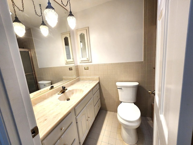 full bath featuring tile walls, toilet, a stall shower, vanity, and tile patterned flooring