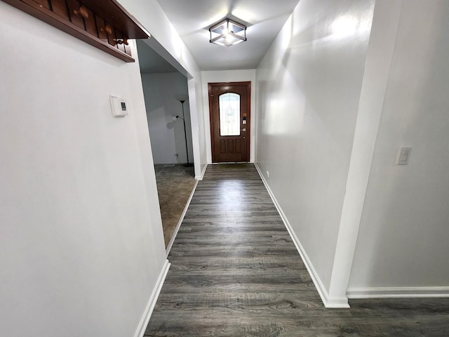 entryway featuring dark wood finished floors and baseboards