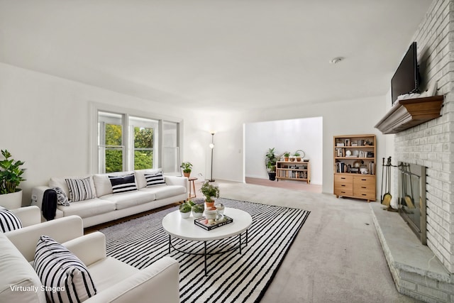 living area with light carpet and a fireplace