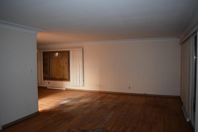 unfurnished room featuring a baseboard heating unit, crown molding, baseboards, and wood finished floors