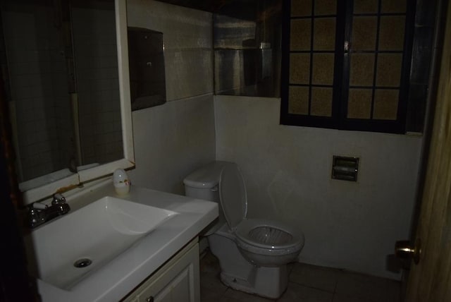 bathroom featuring toilet, vanity, and tile patterned floors