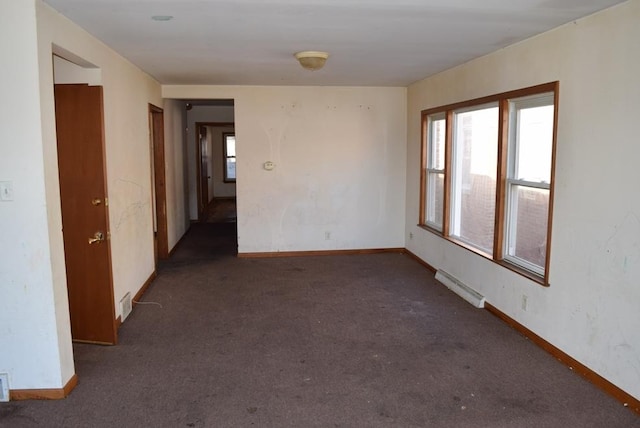 spare room featuring carpet floors, visible vents, and baseboards