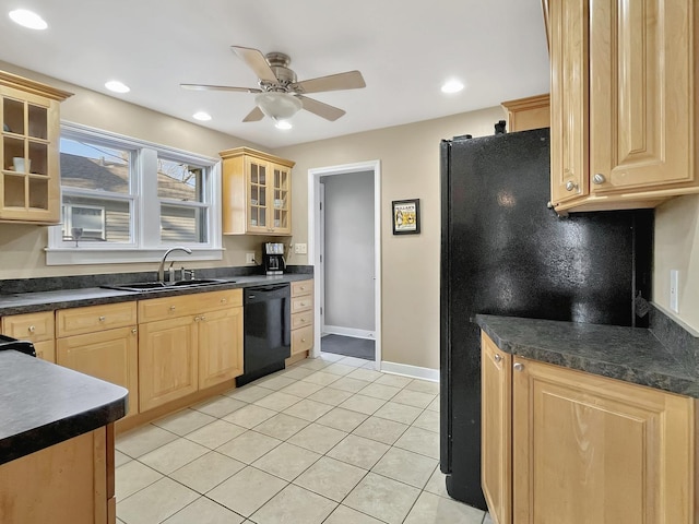 kitchen with light tile patterned flooring, a sink, light brown cabinetry, black appliances, and dark countertops