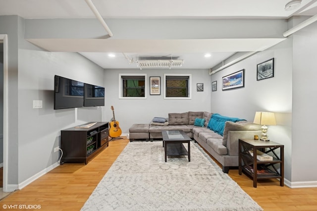 living area featuring light wood finished floors, recessed lighting, and baseboards