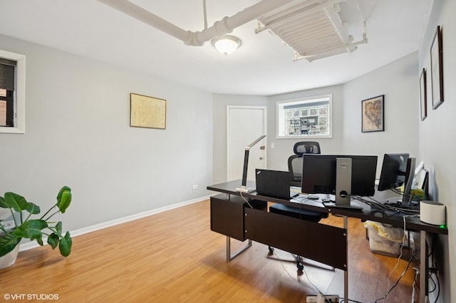 office area with light wood-style flooring and baseboards