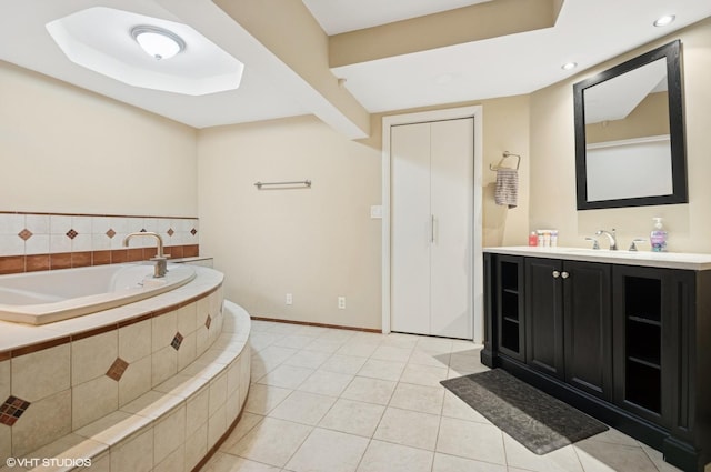 full bathroom featuring baseboards, tile patterned floors, a garden tub, vanity, and recessed lighting