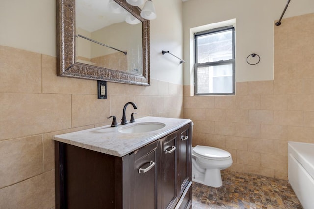 full bathroom featuring toilet, tile walls, and vanity