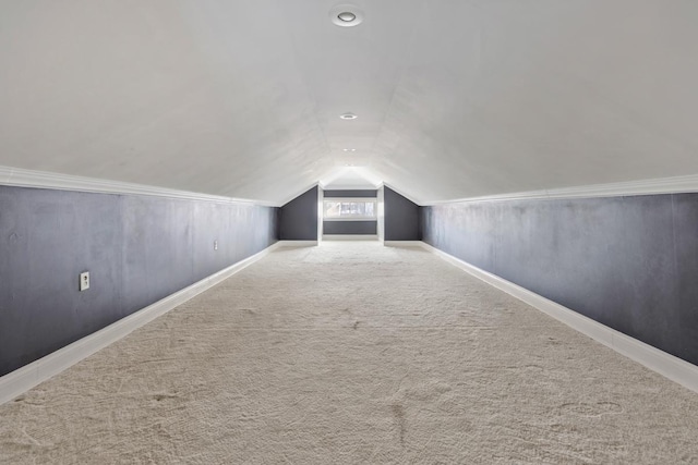 bonus room featuring lofted ceiling, carpet flooring, and baseboards