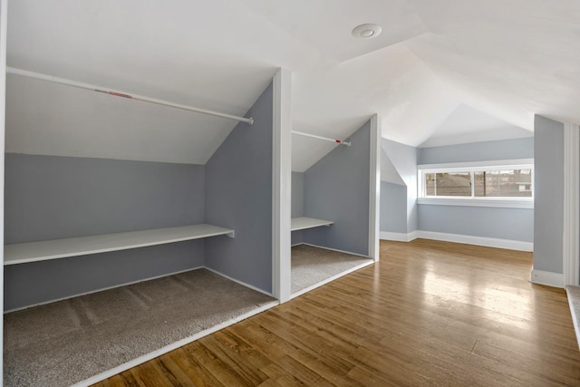 bonus room featuring vaulted ceiling, wood finished floors, and baseboards