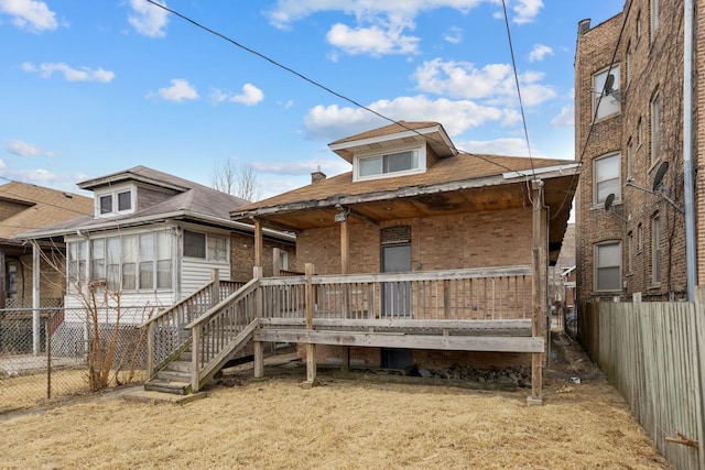 view of front of house featuring fence and brick siding