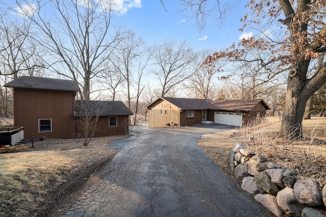 view of front of house featuring a garage and aphalt driveway