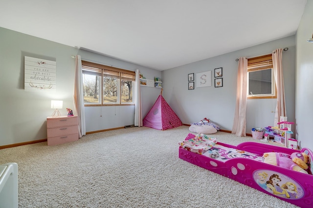 bedroom featuring carpet and baseboards