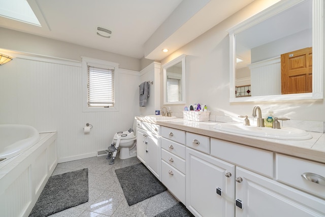 bathroom featuring baseboards, a sink, toilet, and granite finish floor