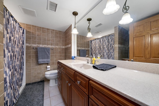 full bathroom featuring visible vents, vanity, tile walls, and tile patterned floors