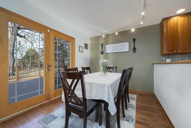 dining space with french doors, wood finished floors, and baseboards