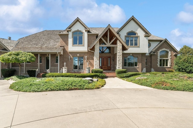 view of front of property featuring brick siding and stucco siding