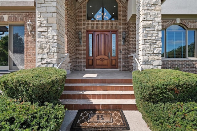 property entrance featuring stone siding and brick siding