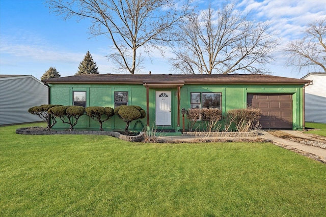 view of front of property featuring a garage, driveway, a front lawn, and stucco siding