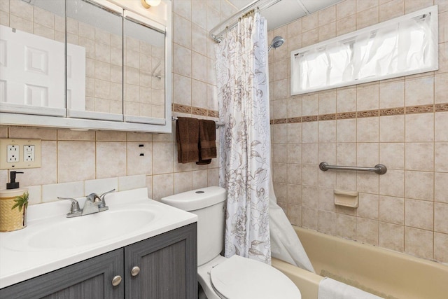 bathroom featuring tile walls, vanity, toilet, and decorative backsplash