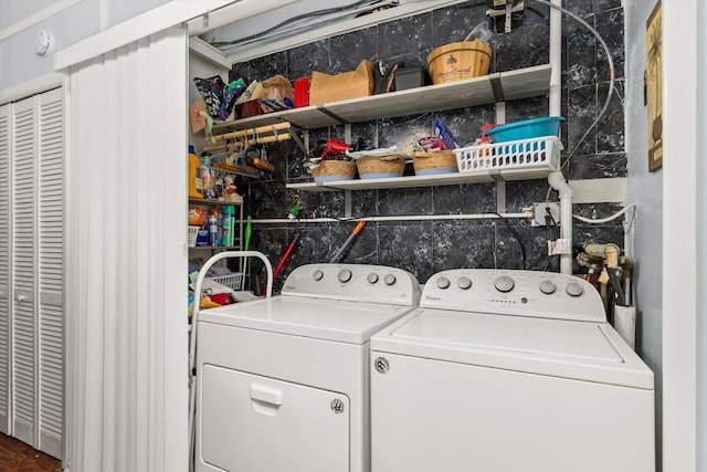 clothes washing area featuring laundry area and washer and clothes dryer