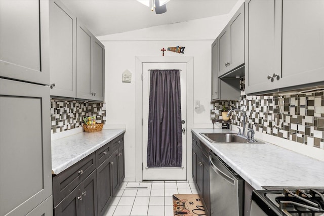 kitchen featuring light countertops, a sink, dishwasher, and light tile patterned floors