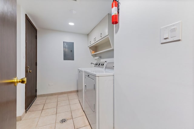 laundry room featuring light tile patterned floors, baseboards, washer and dryer, cabinet space, and electric panel