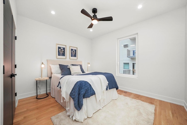 bedroom featuring light wood finished floors, recessed lighting, a ceiling fan, and baseboards