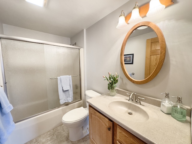 full bath with shower / bath combination with glass door, vanity, and toilet