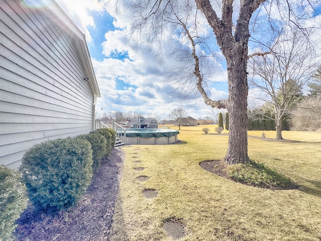 view of yard featuring a covered pool