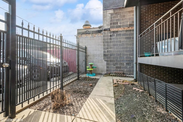 exterior space featuring brick siding and fence