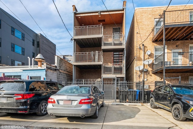 view of building exterior featuring uncovered parking