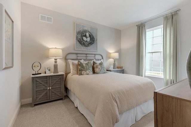 bedroom featuring light colored carpet, visible vents, baseboards, and multiple windows