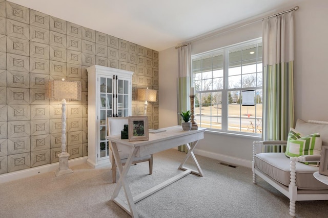 carpeted office with baseboards, visible vents, and wallpapered walls