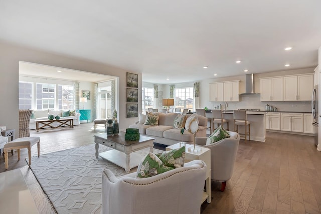 living area featuring light wood-type flooring and recessed lighting