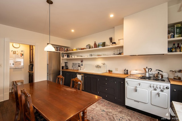 kitchen with a sink, appliances with stainless steel finishes, and open shelves