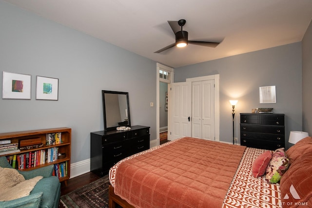 bedroom featuring baseboards, a closet, ceiling fan, and dark wood-style floors