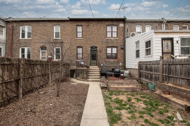 back of property with fence and brick siding
