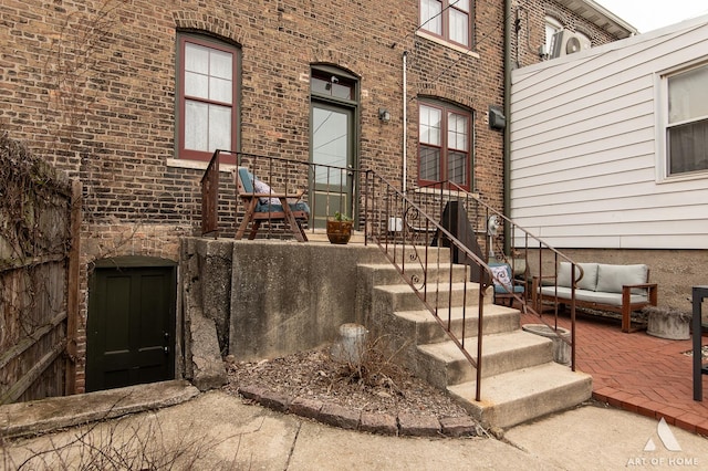 property entrance with brick siding