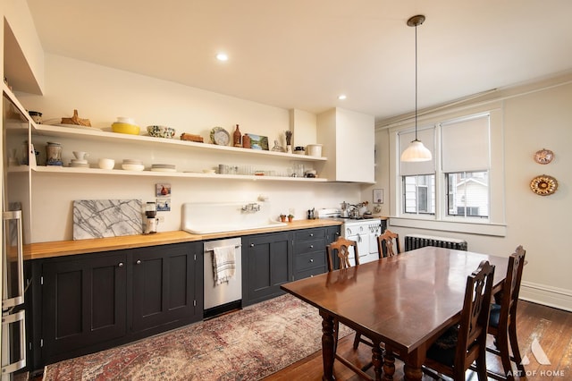 interior space with baseboards, indoor wet bar, radiator heating unit, and dark wood-style flooring