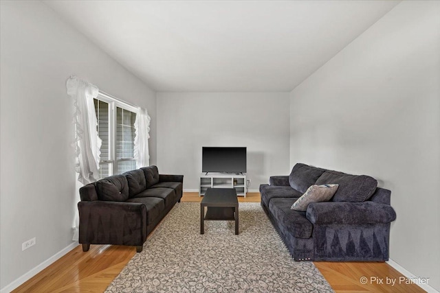 living room featuring light wood-style flooring and baseboards