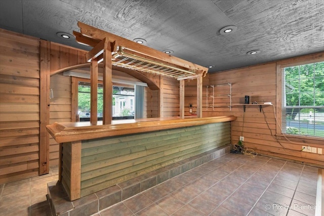 bar with recessed lighting, tile patterned flooring, and wooden walls