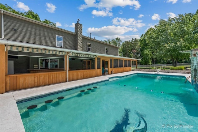 outdoor pool with a sunroom