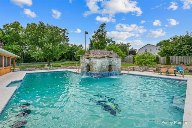 view of swimming pool with a patio, fence, and a fenced in pool