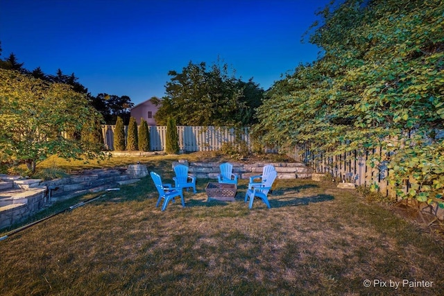 view of yard featuring a fire pit and fence